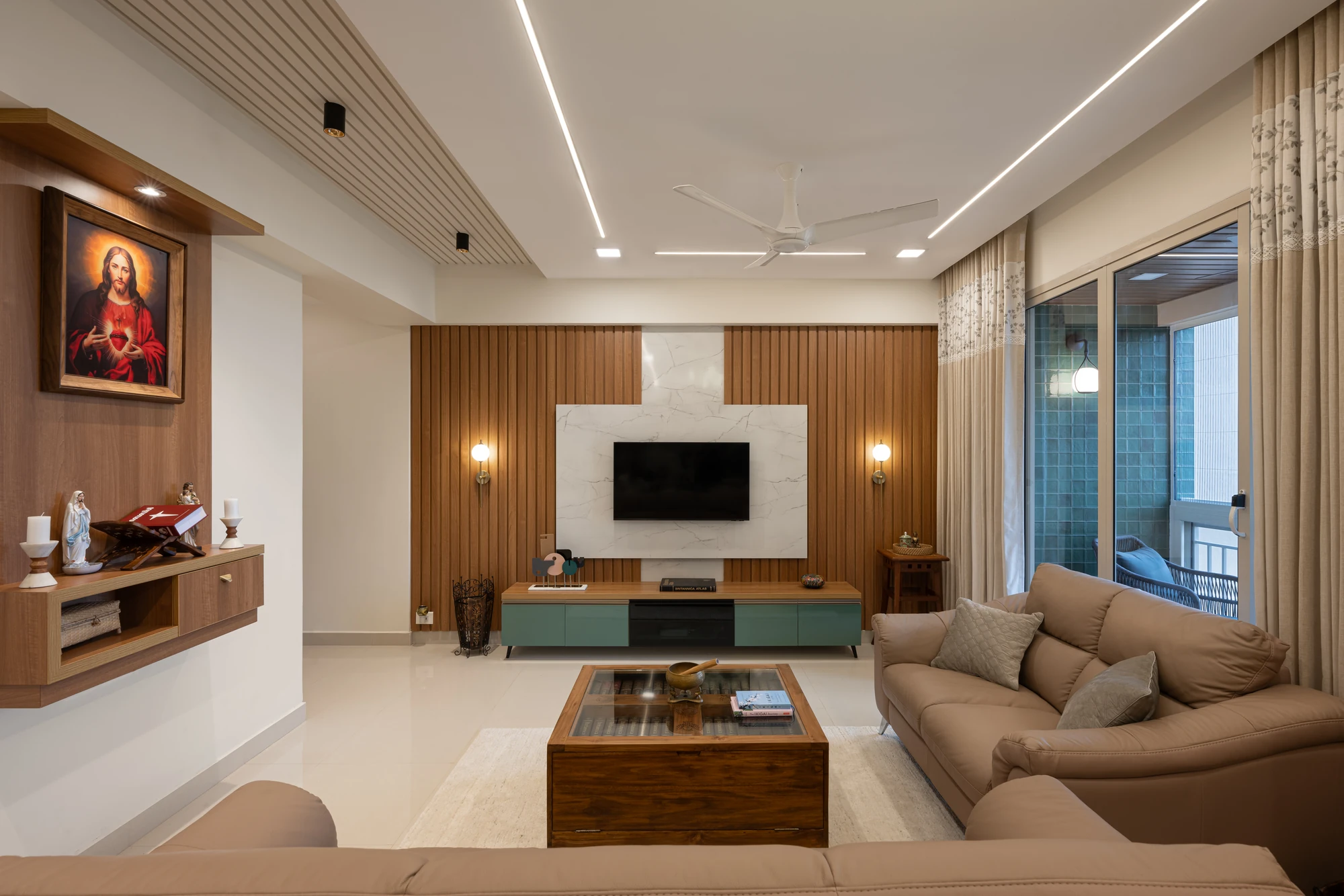 Living room with wood-panel TV wall and leather sofa by Space Decor