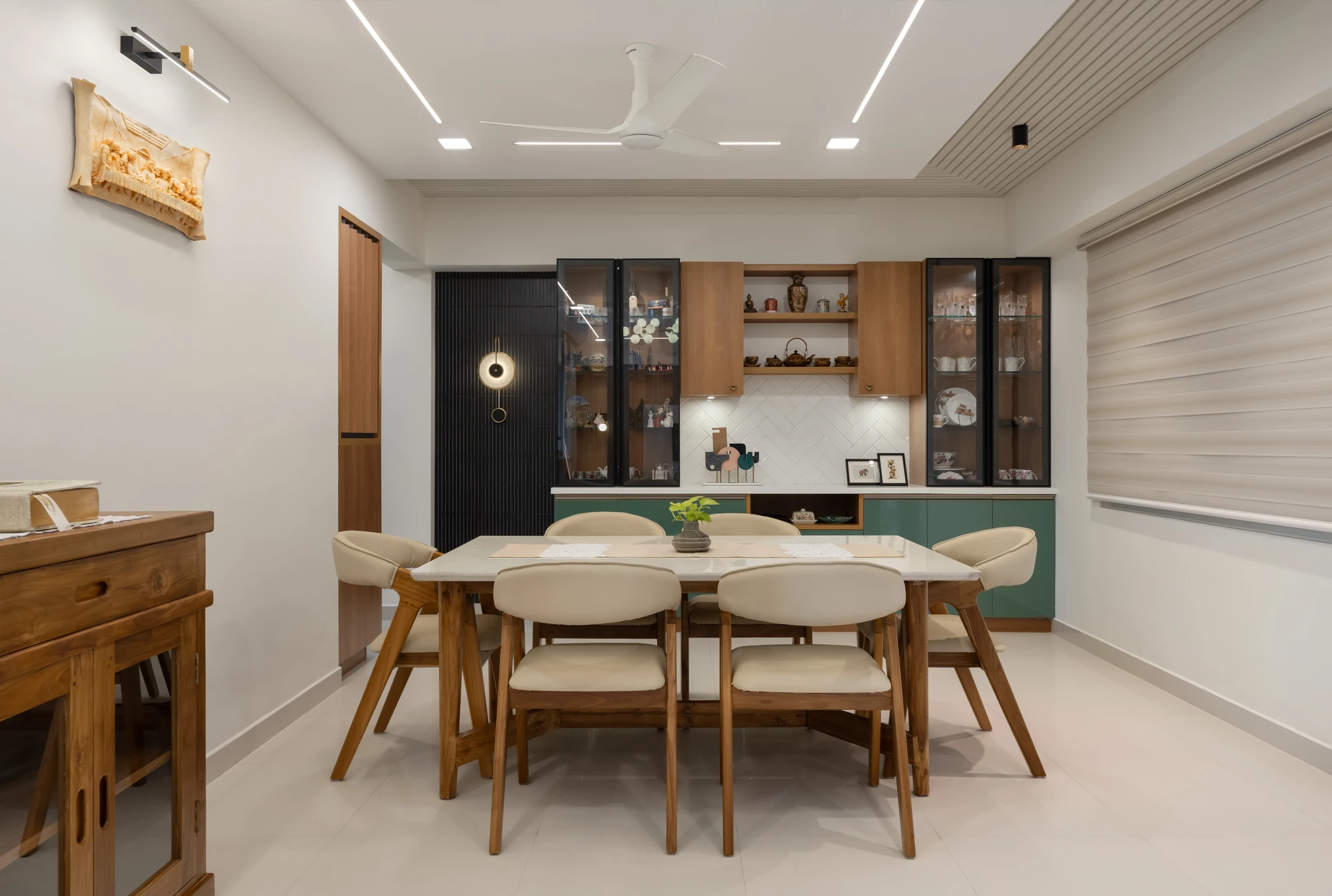 Dining area with crockery units and wooden dining set by Space Decor